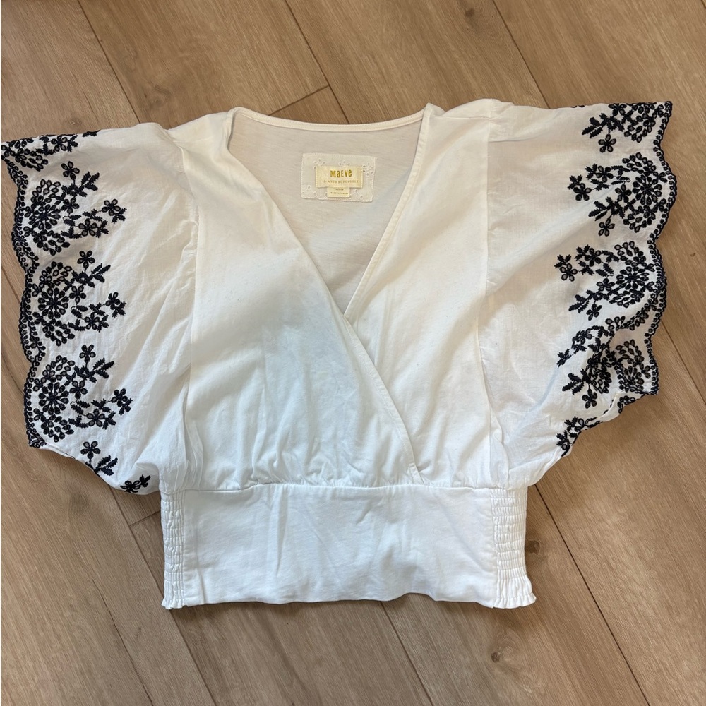 Anthropologie White Wrap Blouse with Black Embellishments
